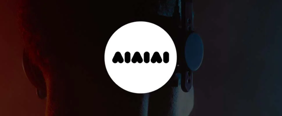 A person wearing headphones is shown from behind, with a rich gradient background of red to blue. A circular logo with the word "AIAIAI" appears on the left.
