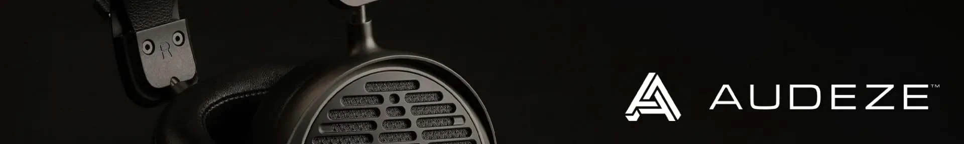 Close-up of a sleek, black Audeze headphone with a mesh grill. The logo "AUDEZE" is prominently displayed on the right against a black background.