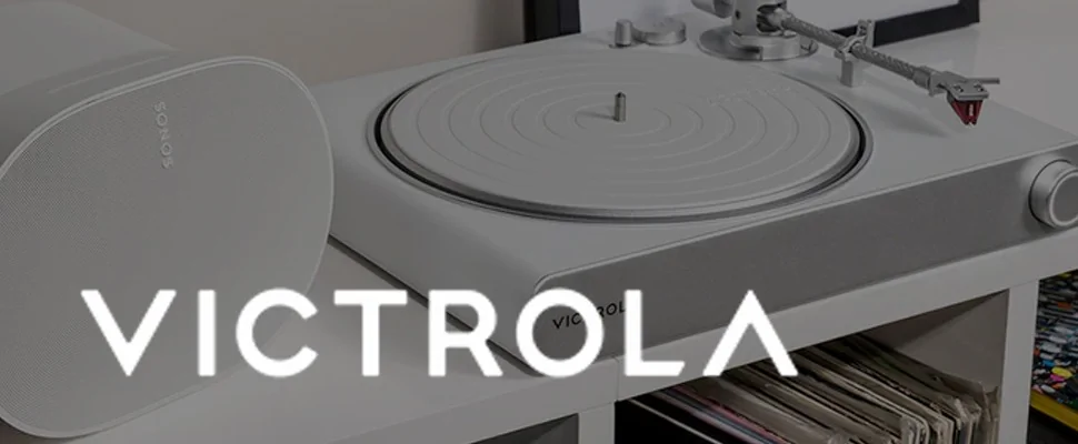 Close-up of a modern grey turntable with a sleek design, featuring the brand name 'Victrola' in bold white text across the centre.