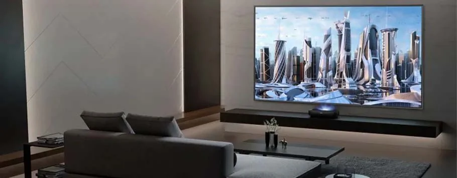 A modern living room with a sleek grey sofa facing a large wall-mounted TV displaying a futuristic cityscape. Monochromatic tones and minimalist design.