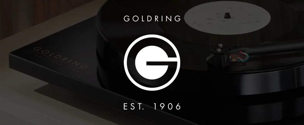 Turntable close-up: A black vinyl record spins on a sleek, modern turntable. The Goldring logo, with "Est. 1906," is visible.