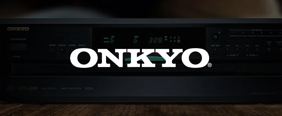 Close-up of an Onkyo audio system with a digital display showing "3:28." It has control buttons and a sleek black design, conveying a modern, sophisticated feel.