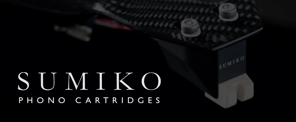 Close-up of a sleek black phono cartridge with textured finish and "Sumiko" text, set against a dark background. Modern and sophisticated design.