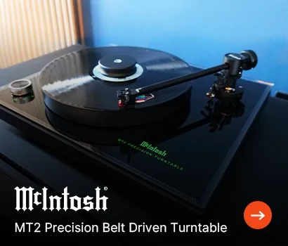 A sleek McIntosh MT2 turntable with a black vinyl record spinning. The tonearm is elegantly positioned, conveying a sense of high-quality audio.