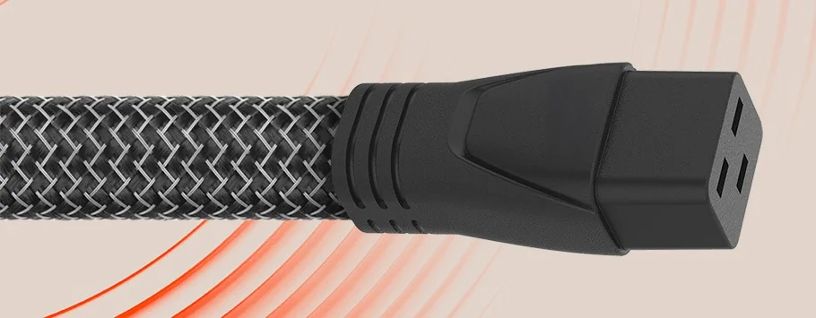 Close-up of a black braided cable with a three-hole electrical connector on a beige background with red curved lines.