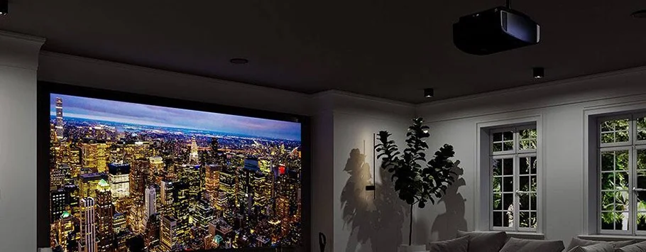 A home theatre room with a large screen displaying a cityscape at night. Cosy seating, plant d&eacute;cor, and warm lighting create an inviting atmosphere.