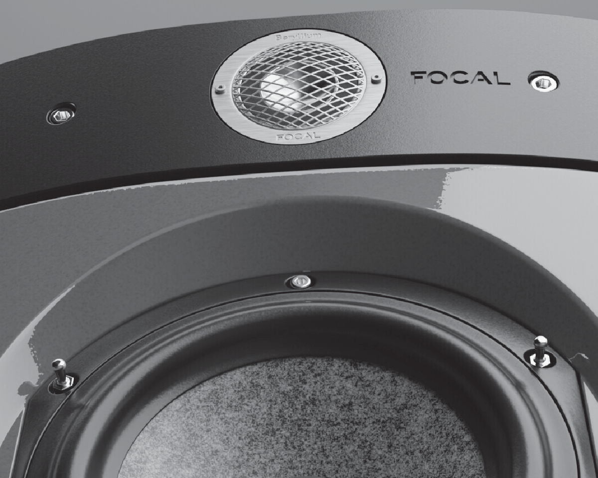 Close-up of a Focal speaker showcasing a glossy black surface with a visible tweeter and woofer. The design conveys a sleek, modern aesthetic.