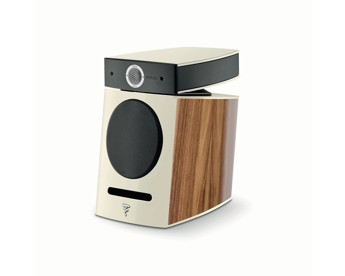 Stylish speaker with a sleek, angular design. Features a wood accent and beige front with a black circular speaker and small grille on top. Modern and elegant.