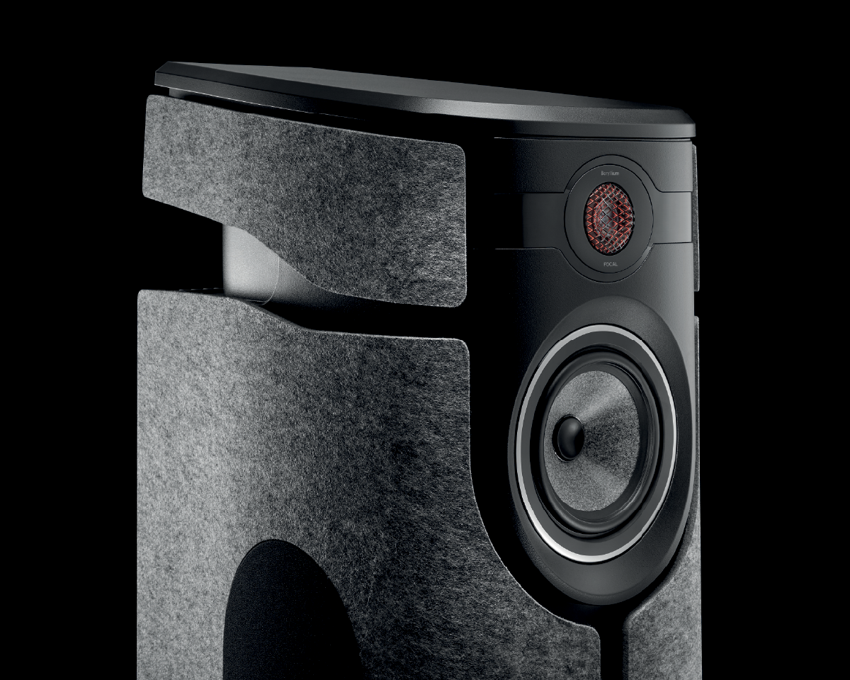 Close-up of a high-end speaker with a sleek black and gray design. The speaker features a large woofer and a small red tweeter, conveying a modern, sophisticated tone.