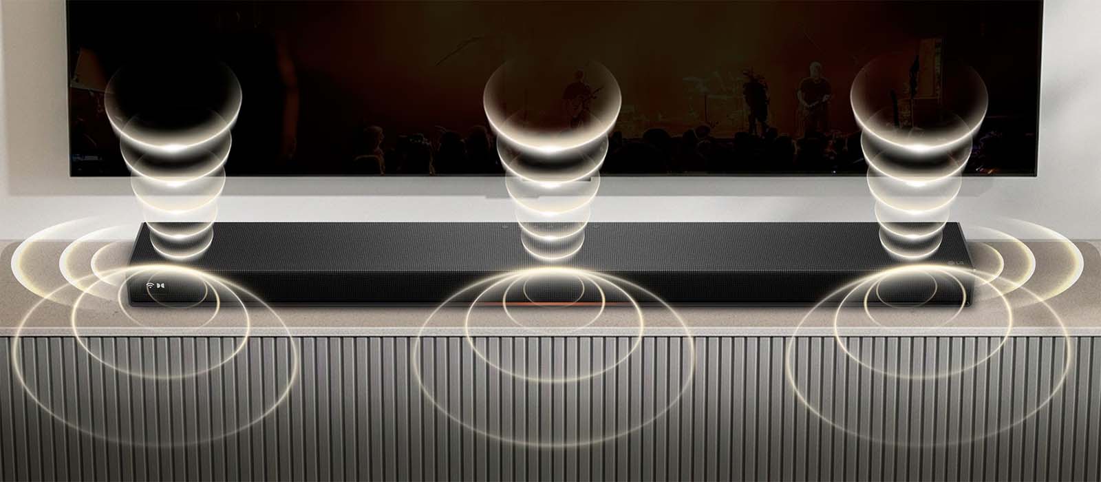 A sleek black soundbar emits visually represented sound waves, depicted as concentric rings, underneath a wall-mounted TV, enhancing audio experience.