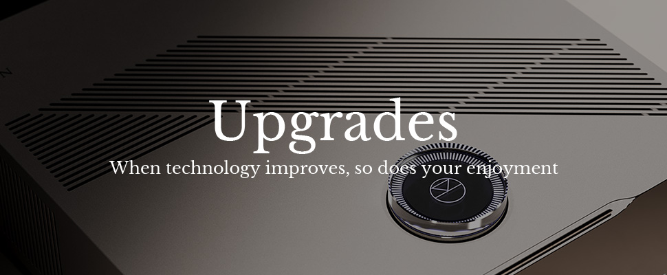 Stylish tech device with sleek metallic design, circular feature, diagonal lines, and text reading "Upgrades: When technology improves, so does your enjoyment."