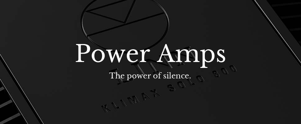 Dark, sleek amplifier surface with embossed text "Klimax Solo 800" and geometric symbol. Overlay text reads "Power Amps" and "The power of silence."