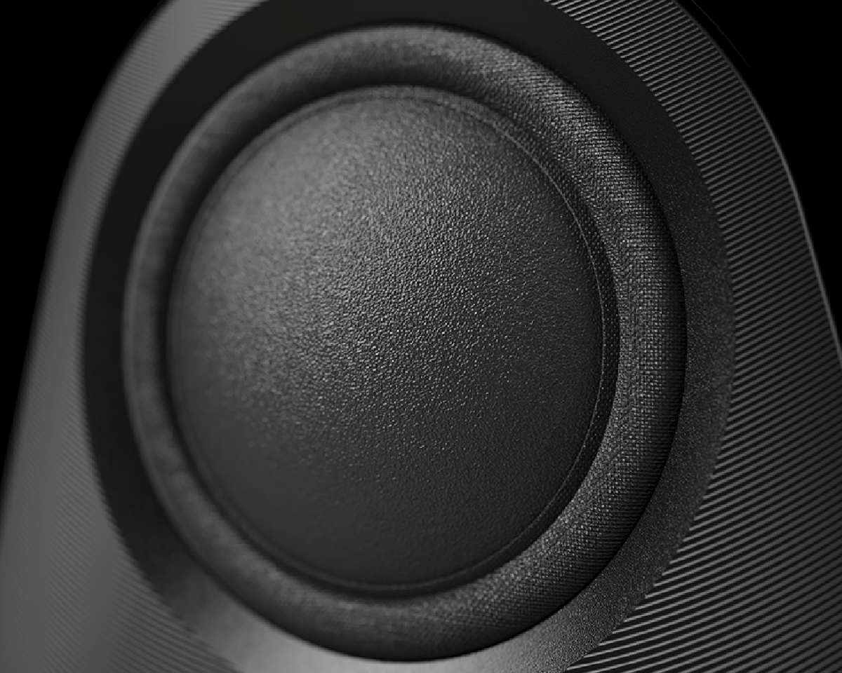 Close-up of a black speaker cone with visible texture and ridged surroundings. The image conveys a sense of precision and modern design.