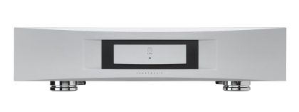 Sleek silver audio amplifier with a minimalist design, featuring a central black display, subtle control buttons, and sturdy metallic feet on a black background.