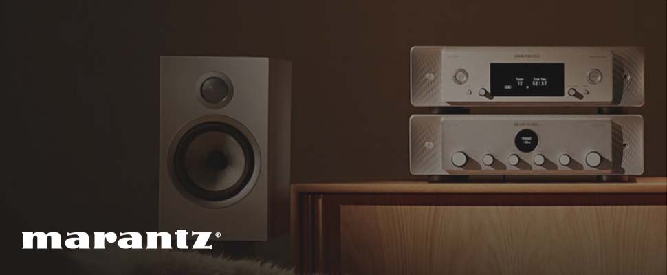 Stereo setup with a sleek speaker, two stacked Marantz audio components on a wooden cabinet. The scene is warmly lit, creating a cozy atmosphere.