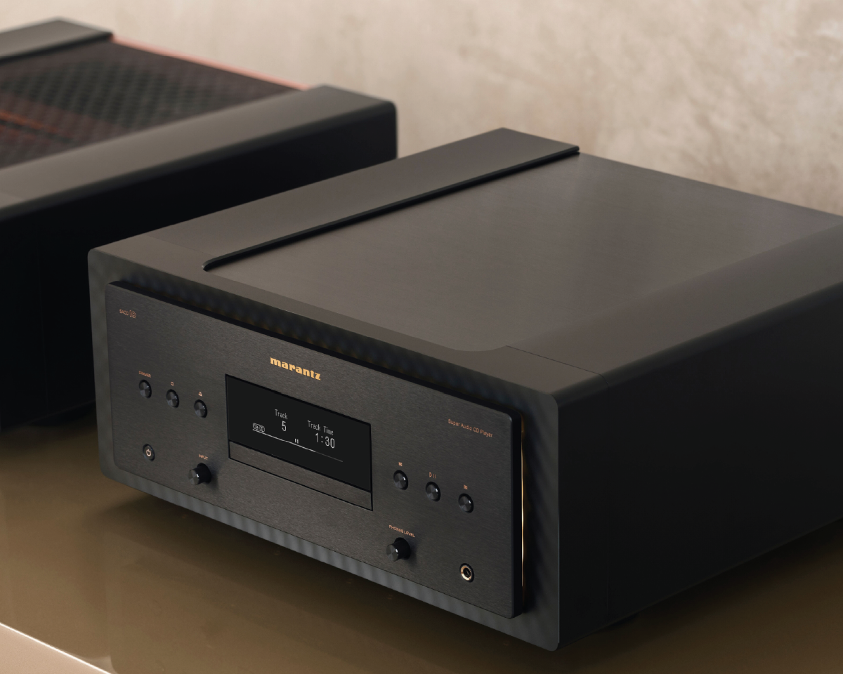 High-end black audio CD player on a table with a digital display showing track details. The sleek design conveys a modern, sophisticated aesthetic.