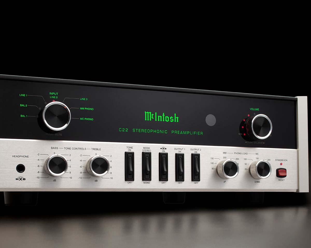 Vintage stereo preamplifier with brushed metal finish, black panel, and green digital display. Features various knobs and buttons for controls.