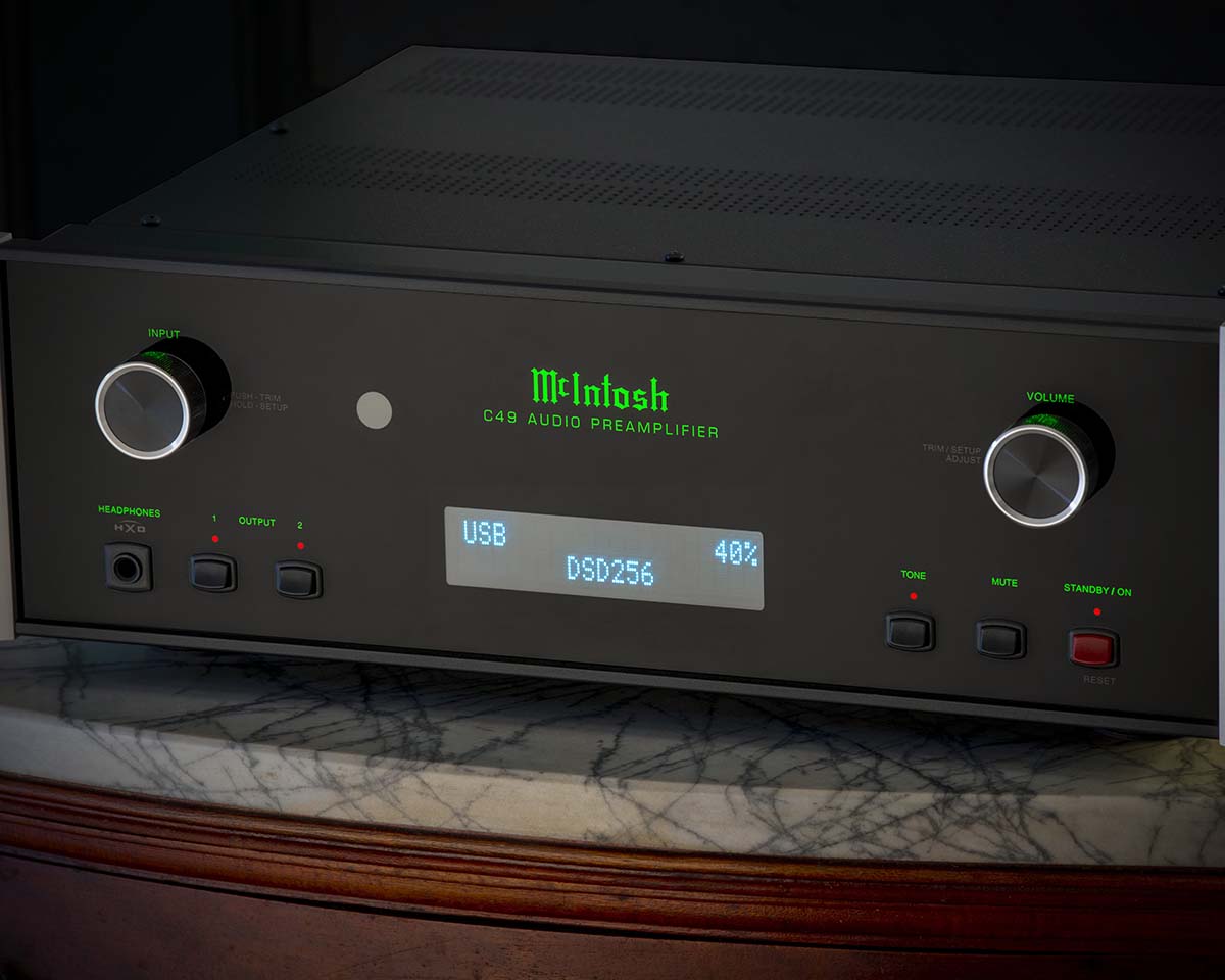 Sleek black audio preamplifier with glowing green text displaying "McIntosh" and "C49 Audio Preamplifier." Central digital screen shows "USB DSD256 40%."
