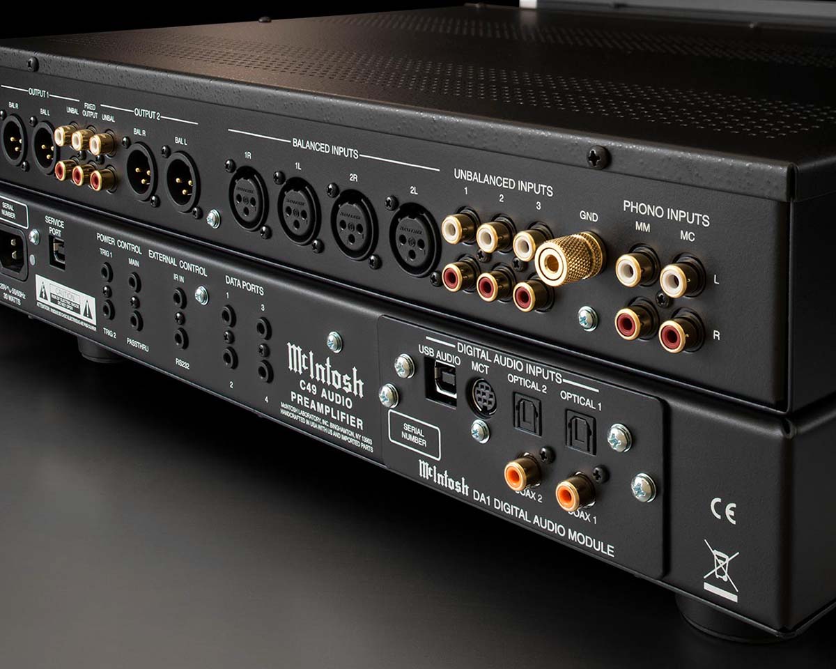 Close-up of the rear panel of a McIntosh C49 audio preamplifier showcasing balanced and unbalanced inputs, phono inputs, and digital audio inputs.