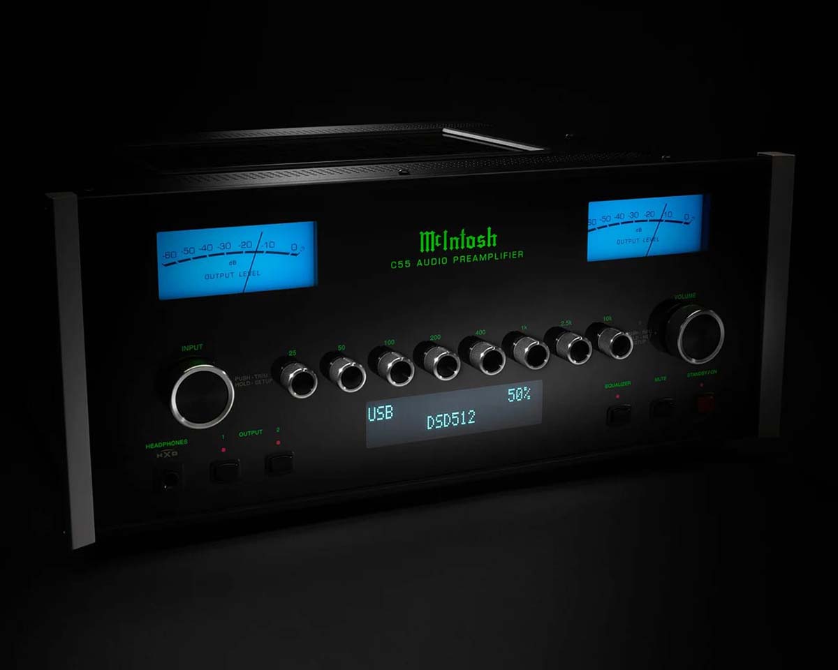 Sleek black McIntosh C53 audio preamplifier with glowing blue meters and green text, displaying USB input and DSD512, knobs for adjustment.