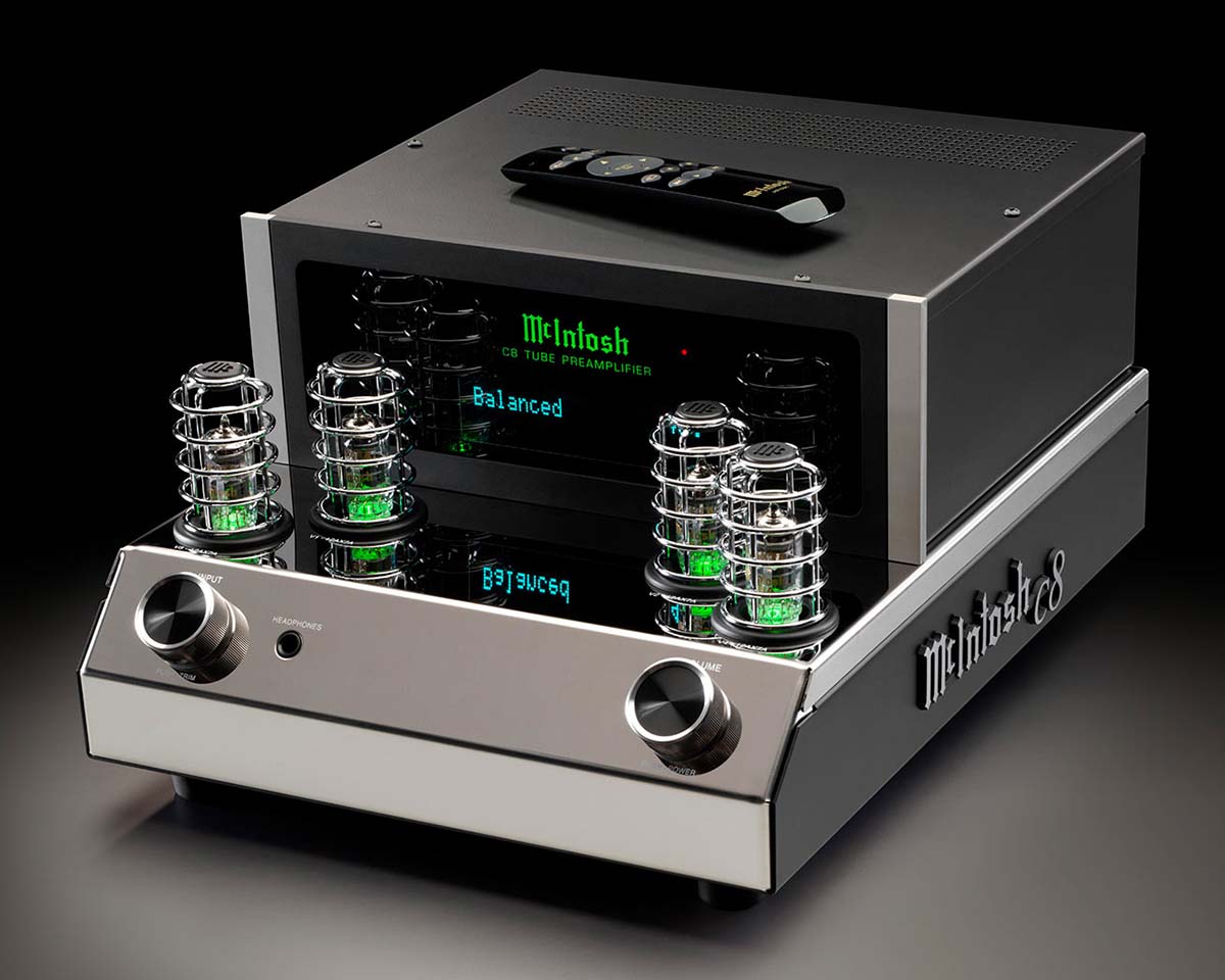 Vintage-style McIntosh C8 tube preamplifier with glowing green vacuum tubes, polished metal finish, and a small remote control, exuding a classic, high-end tone.
