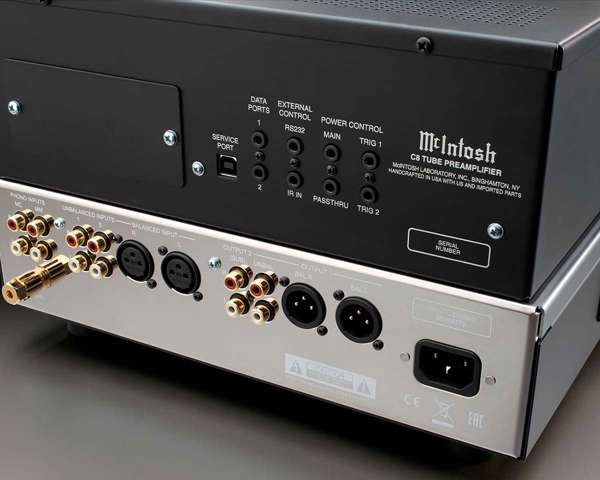 Back view of a McIntosh C8 tube preamplifier. It features various audio input and output ports, including phono, unbalanced, and balanced connectors. Sleek design with clear labeling enhances usability.
