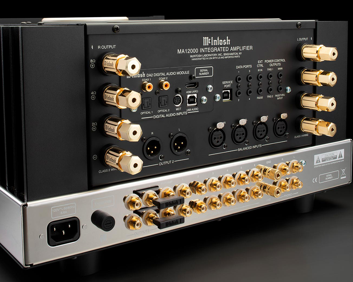 The back panel of a McIntosh MA12000 Integrated Amplifier features multiple gold-plated input and output connectors, knobs, and digital audio ports.