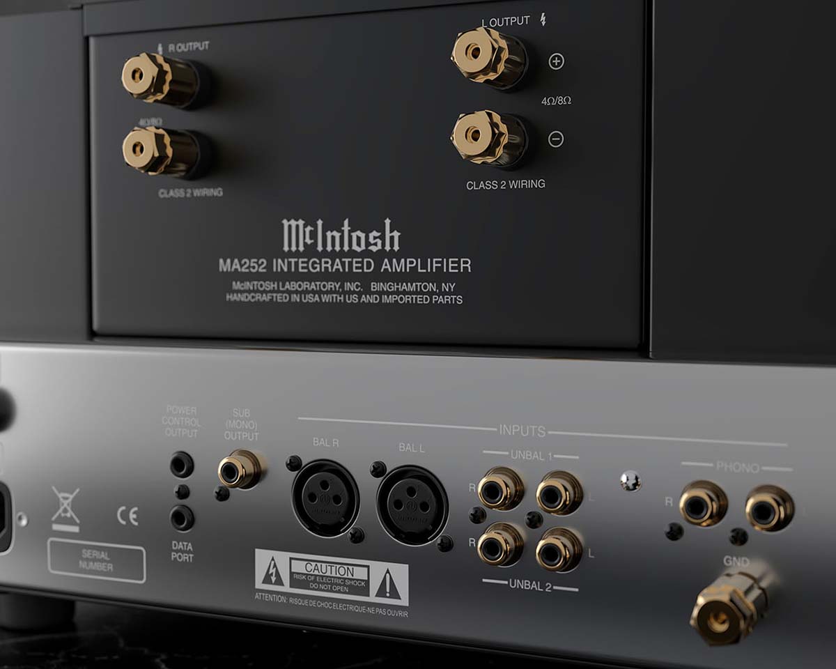 Close-up of a McIntosh MA252 Integrated Amplifier's rear panel, showcasing speaker outputs, audio inputs, and connectors. The design is sleek and professional.