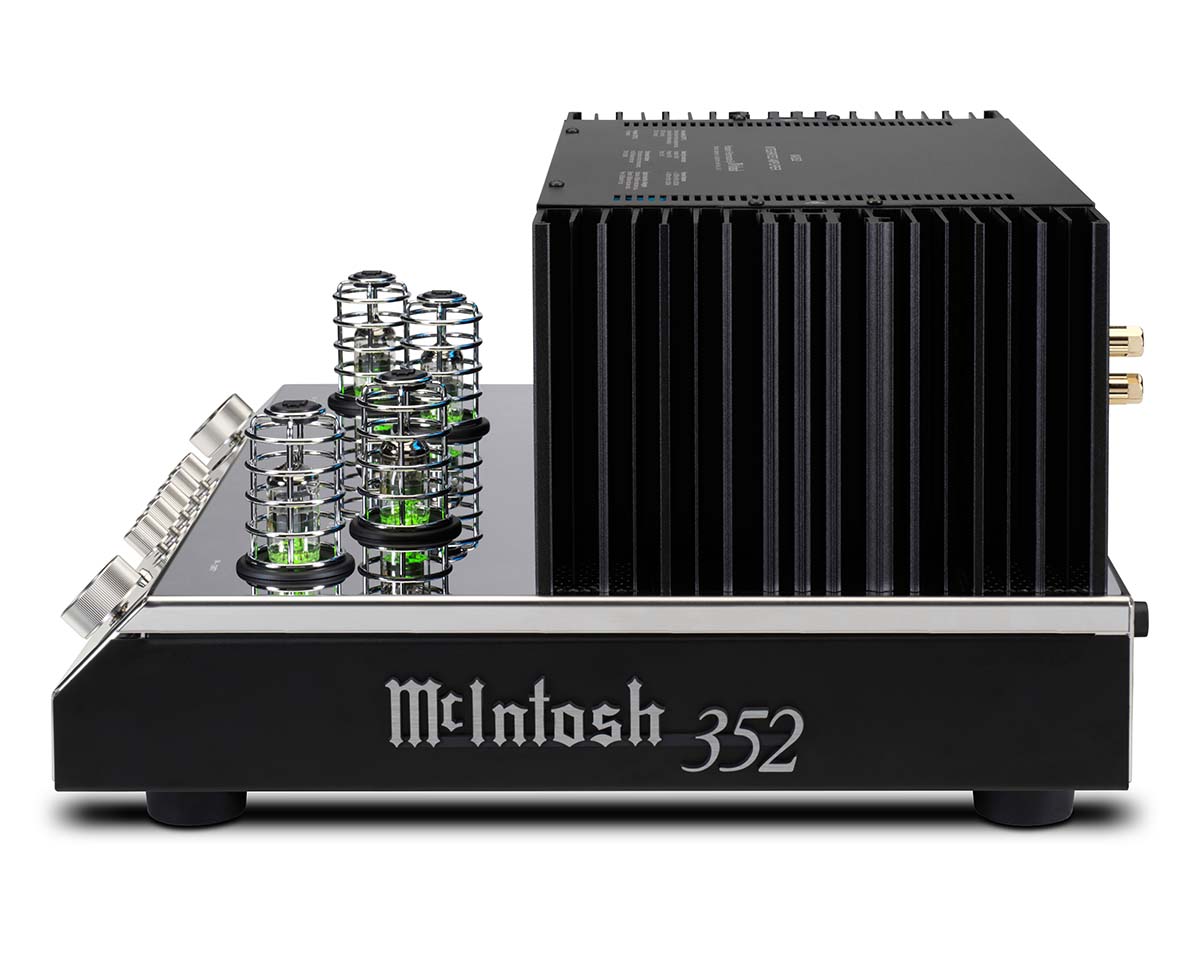 Side view of a McIntosh 352 amplifier featuring exposed vacuum tubes with a green glow on the left and a large black heat sink on the right. Sleek, modern design.
