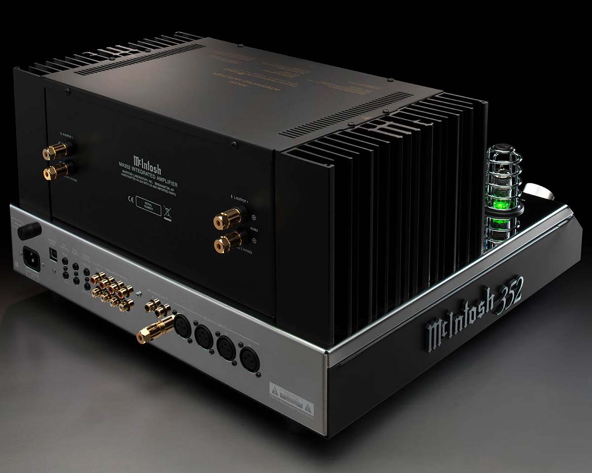 Sleek McIntosh 352 amplifier with a black finish, prominent cooling fins, gold connectors, and glowing green tubes, exuding a high-end, professional allure.