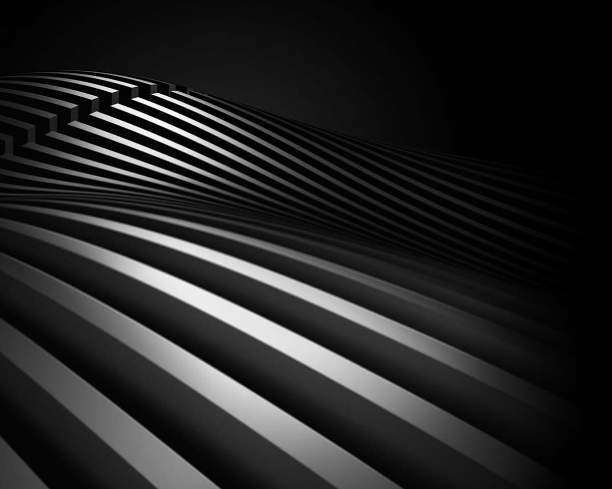 Abstract black and white image featuring undulating parallel lines creating a wave-like pattern. The lighting enhances the sense of depth and motion.