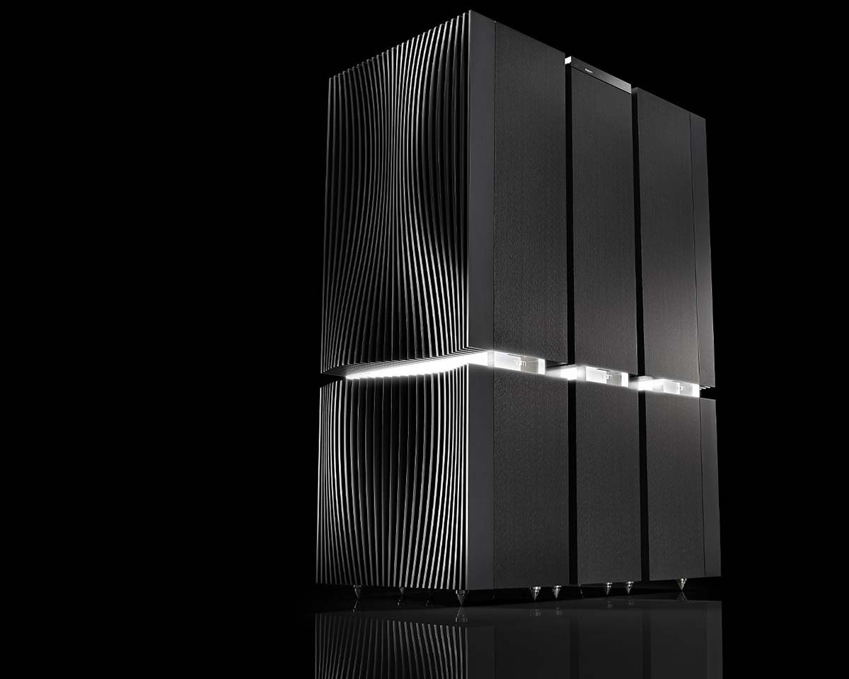 Sleek black computer server with vertical lines, illuminated by white lights, standing against a dark background. Modern and futuristic design.