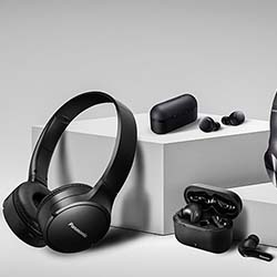 Black headphones and earbuds are displayed on a minimalist white surface. The scene conveys a modern, stylish, and high-tech feel.