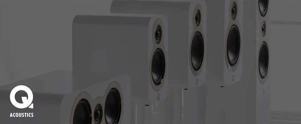 Four sleek white speakers with a minimalist design are aligned in a row. The Q Acoustics logo is in the bottom left corner, emphasizing quality sound.