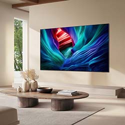 A modern living room features a wall-mounted TV displaying vibrant abstract art with swirling blues and reds. Minimalist decor and serene, elegant vibe.