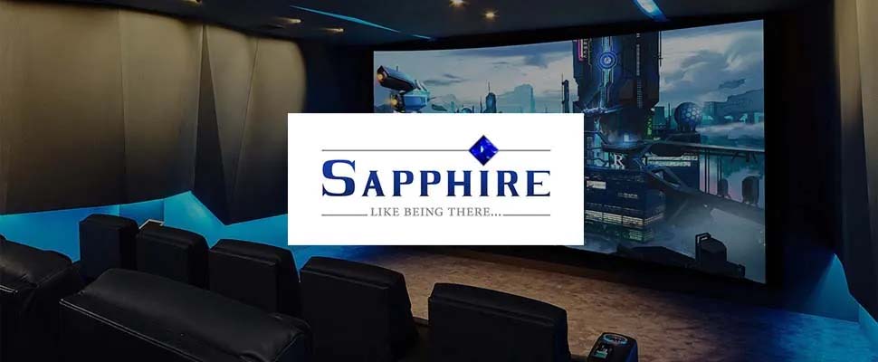 Luxurious home theater room with black leather seats facing a large screen displaying a futuristic cityscape. "Sapphire - Like Being There" logo overlays the center.