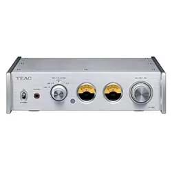 Silver audio amplifier with brand logo on left. Features include a headphone jack, control knobs, and two orange-backlit dials, conveying a vintage tech vibe.