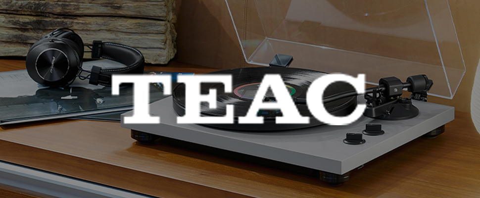 A turntable with a vinyl record and headphones on a wooden surface. The word "TEAC" is boldly overlaid, evoking a vintage and musical atmosphere.