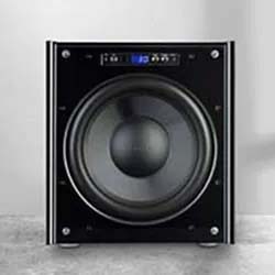 A black subwoofer with a large central speaker cone, digital display, and control buttons on top, set against a light gray background.