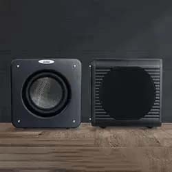 Black audio speakers on a wooden surface against a dark background. The speakers have a modern, sleek design, conveying a minimalist and stylish tone.