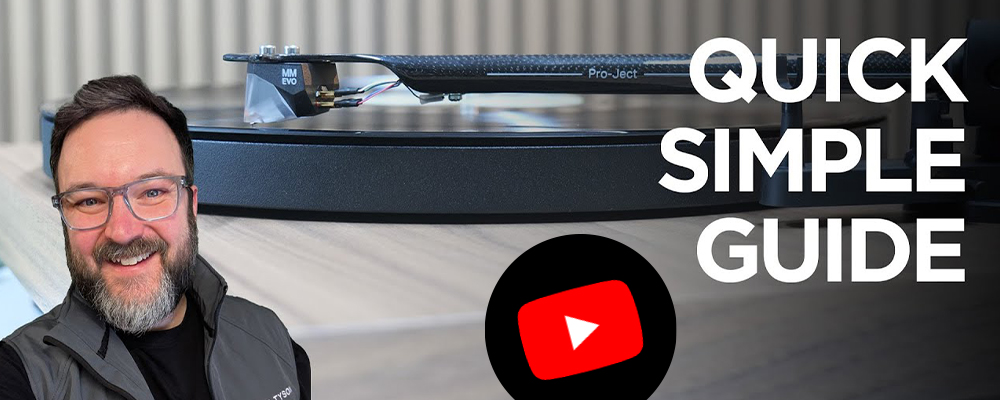 Smiling man with glasses next to a turntable. Text reads "Quick Simple Guide." A YouTube logo is overlaid, suggesting video content.