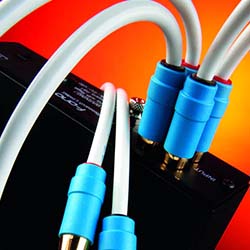 Close-up of white cables with blue connectors plugged into a black electronic device, set against a vibrant orange background, conveying a tech theme.