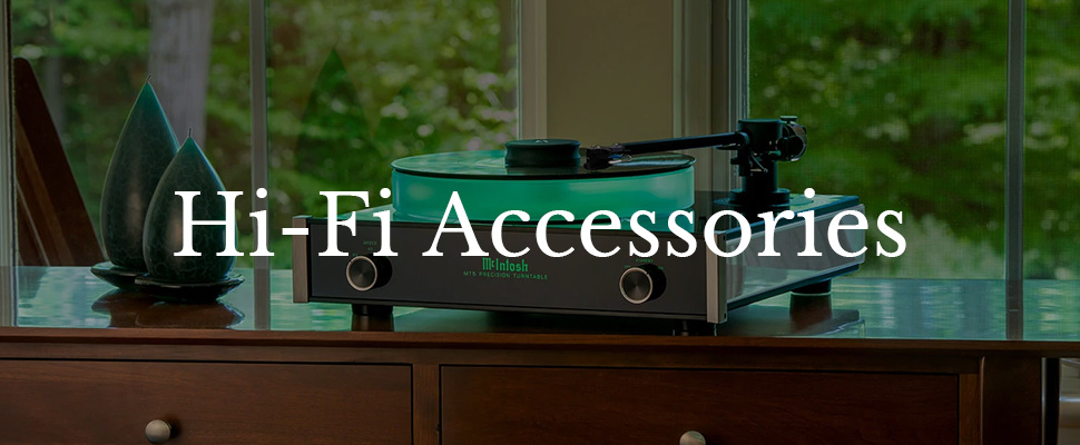 Turntable with glowing elements sits on a wooden cabinet, topped with text "Hi-Fi Accessories." Greenery outside the window adds a serene backdrop.