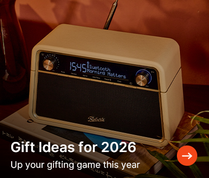 Vintage-style radio with a sleek cream and black design on a table, displaying "Bluetooth Morning Matters." Text reads "Gift Ideas for 2026." Cozy ambiance.