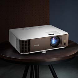 A sleek, modern projector emits a soft blue light on a dark wooden table against a muted background, conveying a tech-savvy, minimalist vibe.