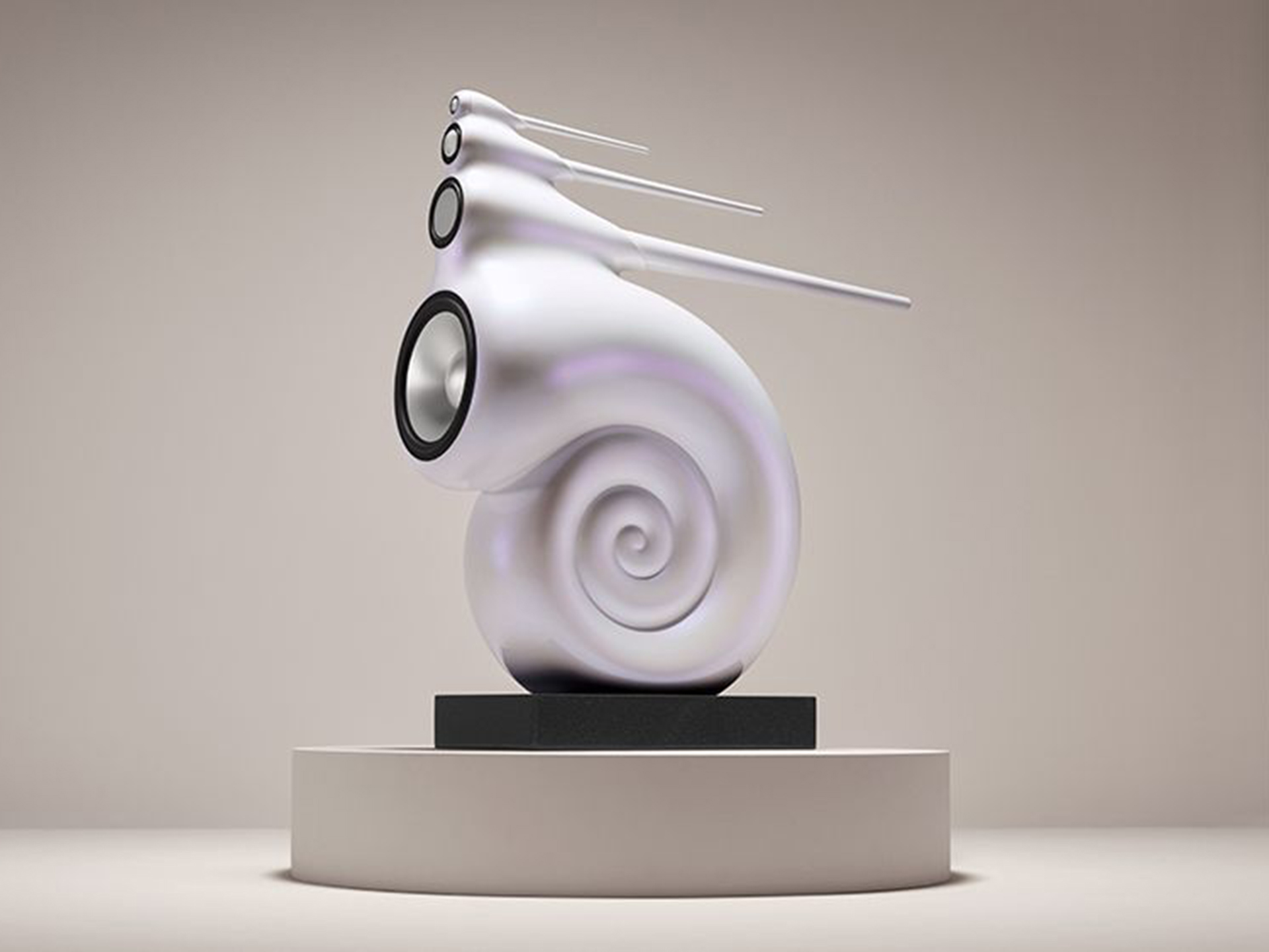 A sleek, modern speaker designed like a white, spiral shell with multiple drivers, set on a pedestal against a neutral background, conveying a futuristic and artistic vibe.