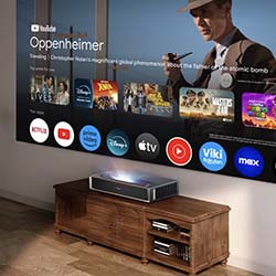 A home projector displays a streaming interface on a wall, featuring a film titled "Oppenheimer." Various streaming app icons are shown below the film.