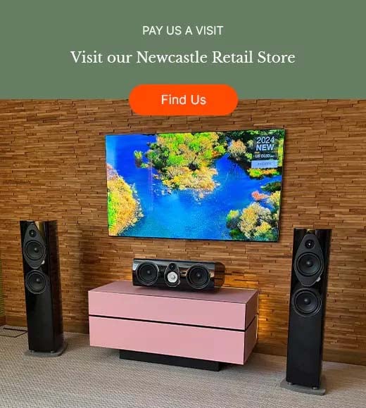 Modern entertainment setup with a wall-mounted screen displaying vibrant nature scenery. Two black speakers flank a pink TV stand, set against a textured wall.