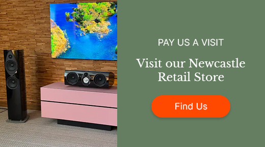 Home audio setup with a TV displaying scenery, speakers, and a pink cabinet on a wicker wall backdrop. Text on a green background: "Visit our Newcastle Retail Store" with an orange "Find Us" button.
