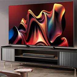 A large, modern TV displaying colorful abstract waves in red, orange, and blue tones. It sits on a sleek black console in a stylish living room.